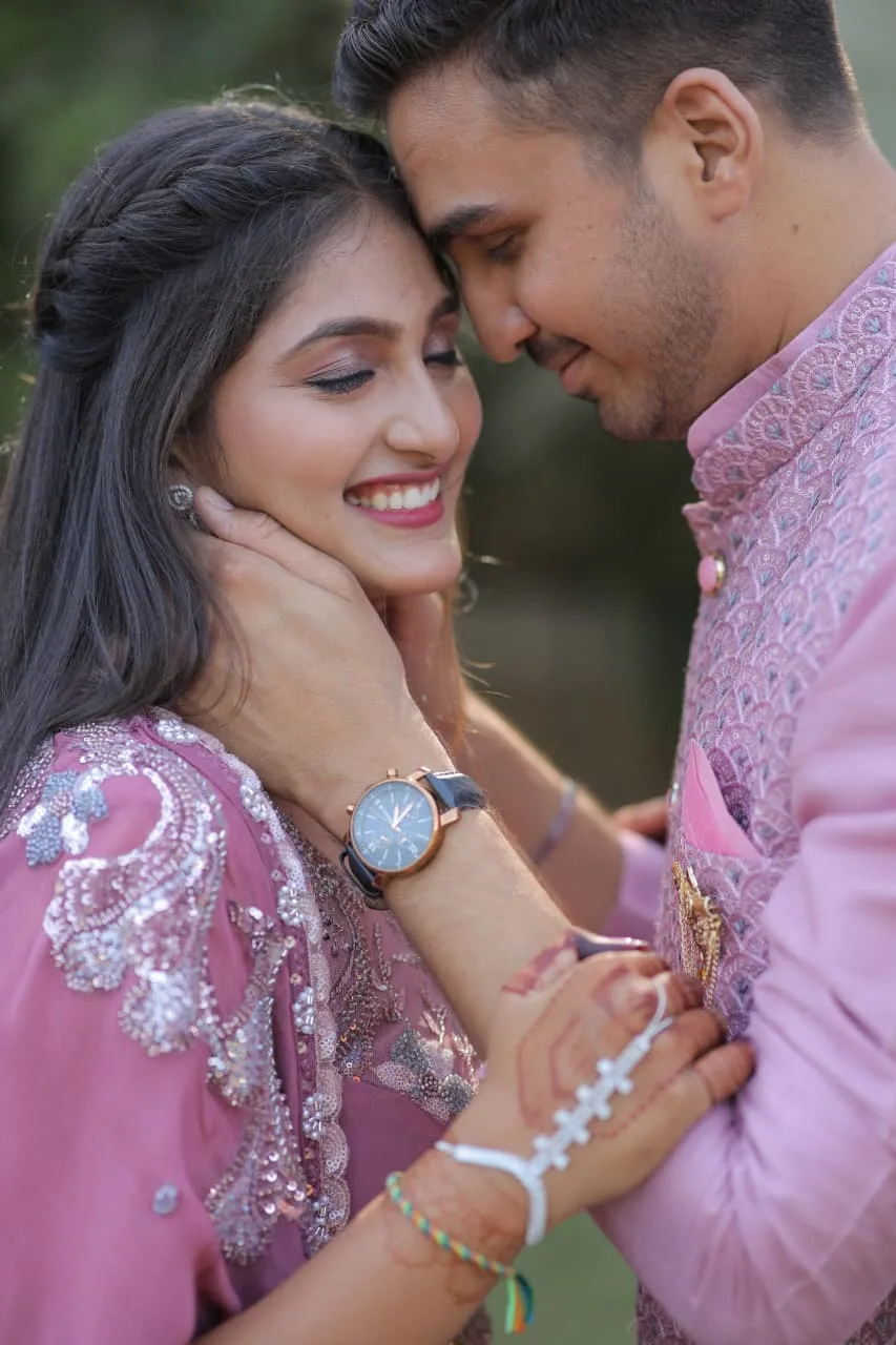Neha and Sahil cheek to cheek, Neha smiling with her eyes closed
